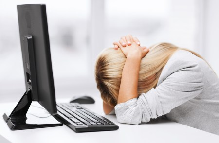 Woman with her head down on her desk in fatigue