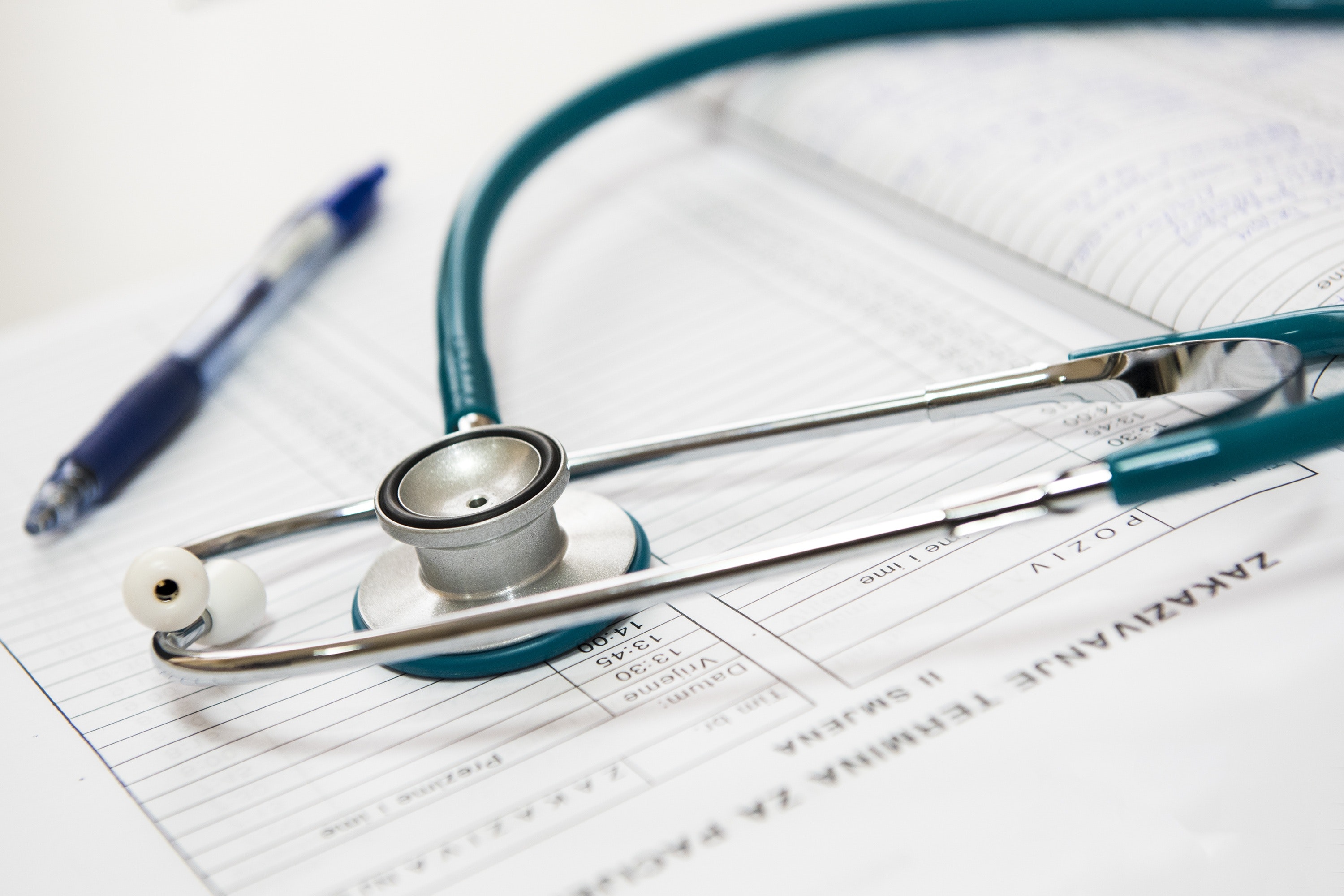 stethoscope on top of medical paperwork