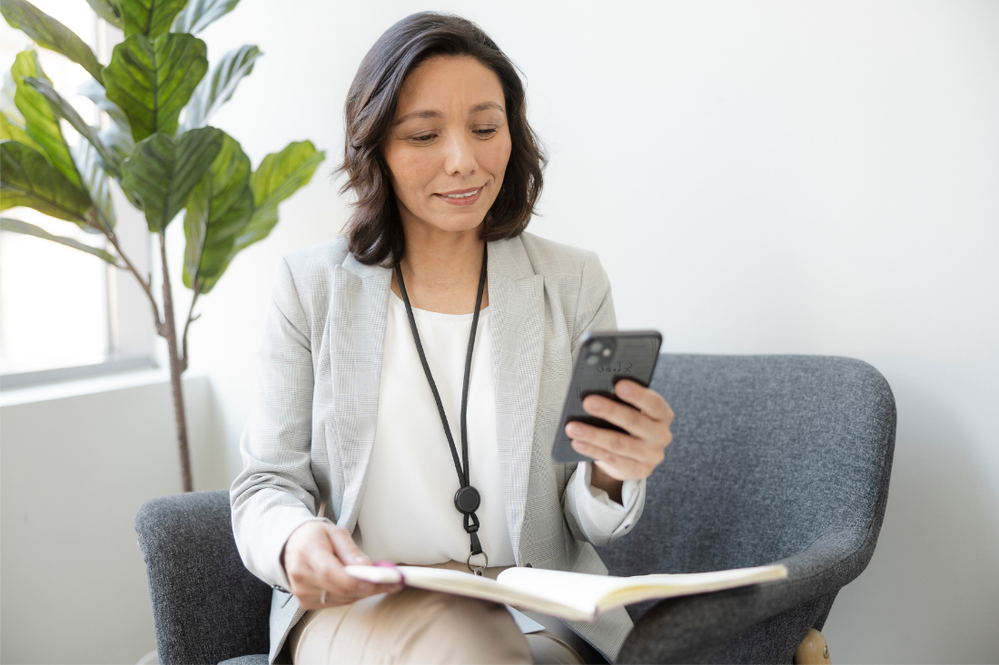 A female doctor uses her mobile phone.