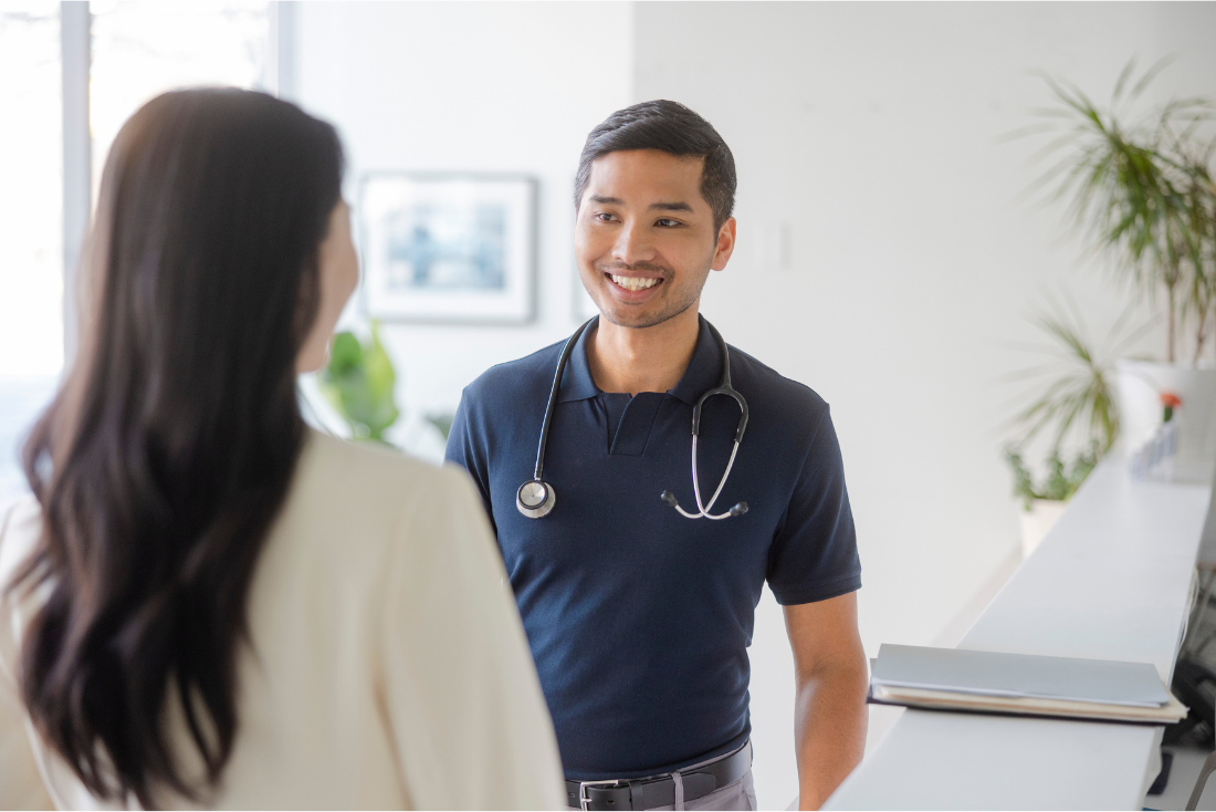 Two doctors chat in the office halls.