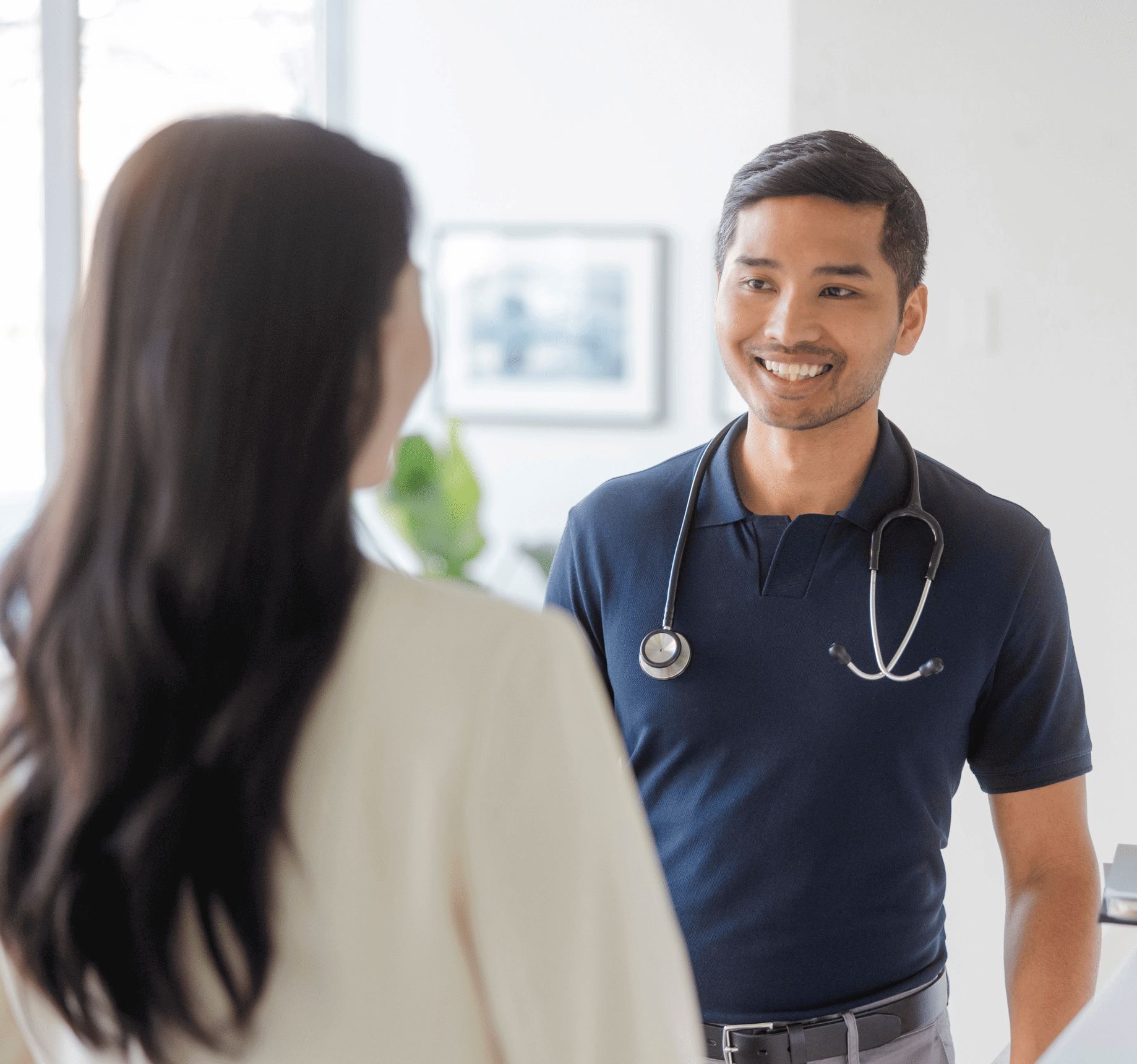 Two doctors chat in the office halls.