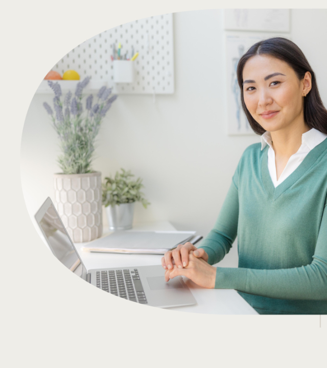 Female doctor types at her laptop.