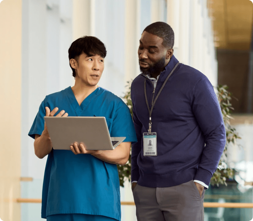 Two physicians looking at laptop