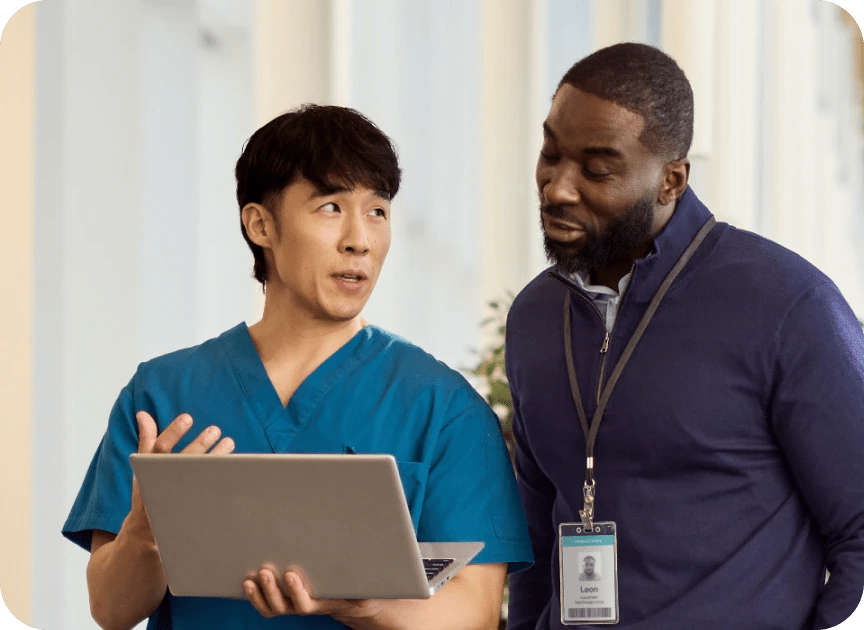 Two physicians looking at laptop