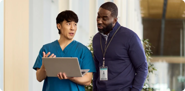 Two physicians looking at laptop