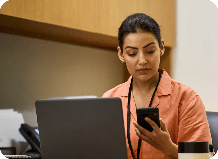 Billing admin looking at phone