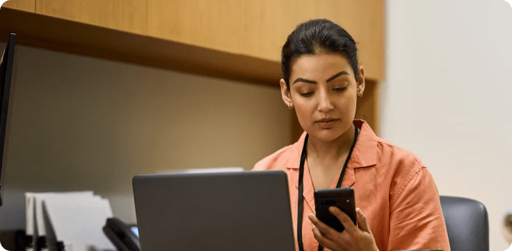 Billing admin looking at phone