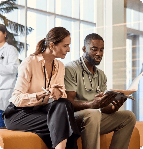 Two physicians discussing documents