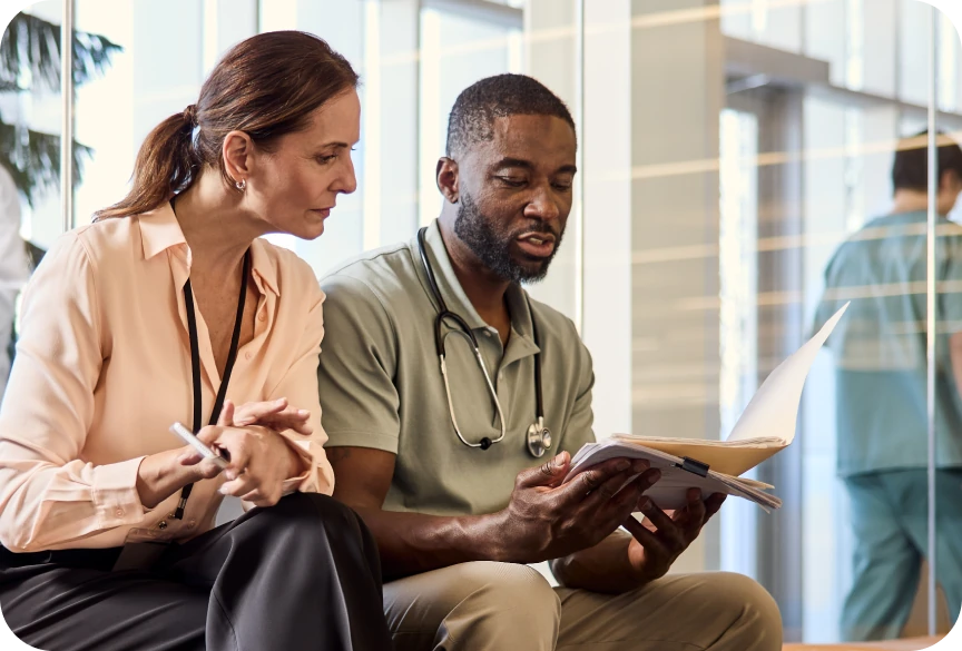 Two physicians discussing documents